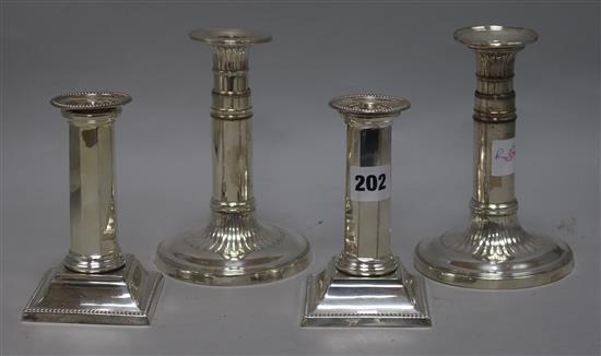 Two pairs of plated candlesticks